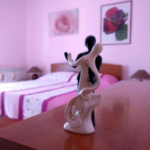 a figurine of a woman sitting on a table in a bedroom at Anica Apartment in Banjole