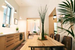 a dining room with a table with a potted plant at El Sayed House in Acre