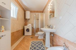 a bathroom with a sink and a toilet and a shower at Apartment Macan in Bale