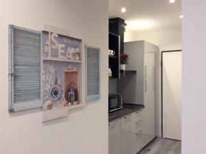 a kitchen with white cabinets and a window and a microwave at Granduca in Bologna