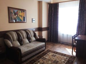 a living room with a couch and a window at Oka Hotel in Ryazan