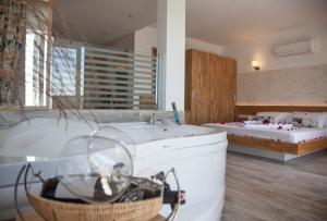 a large bathroom with a tub and a bath tub at Nur Hotel in Kaş