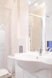 a white bathroom with a sink and a toilet at Dworek Zyskowskiego in Danowskie +84 photos
