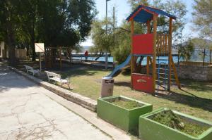 a playground with a slide in a park at studio apartman Kata in Prvić Šepurine