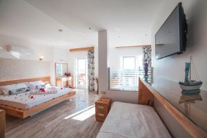a bedroom with a bed and a flat screen tv at Nur Hotel in Kaş