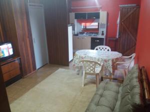 a living room with a table and a couch at Apartamento Dois in Caxias do Sul