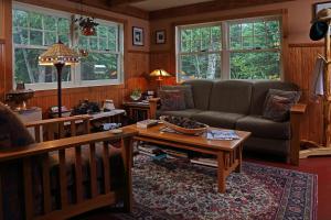 a living room with a couch and a coffee table at Poplar Creek Guesthouse in Grand Marais