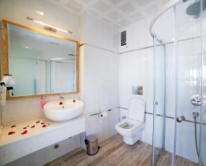a bathroom with a sink and a toilet and a shower at Nur Hotel in Kaş