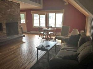 a living room with a couch and a table at The Upper Pass Lodge in Londonderry