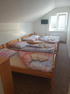 A bed or beds in a room at Ubytování U Františka