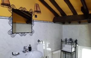 a bathroom with a sink and a mirror at La Casona de Sames in Sames