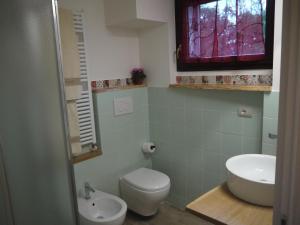 a bathroom with a toilet and a sink at "CARA PACE" in collina - Guest House in Montefiore Conca +57 photos