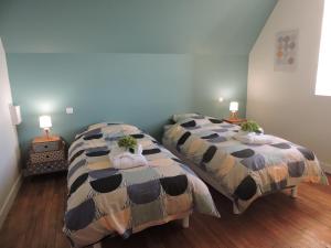 2 Betten nebeneinander in einem Zimmer in der Unterkunft Logis du Petit Dodo in Sainte-Jamme-sur-Sarthe
