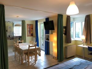 a kitchen and dining room with a table and chairs at Wonderful Apartment With Great Location in Kaiserslautern