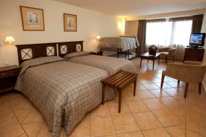 Säng eller sängar i ett rum på Hotel Telecabina