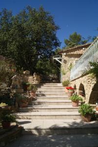 a stone pathway with potted plants and a building at Le Mas des Chênes in Rognes