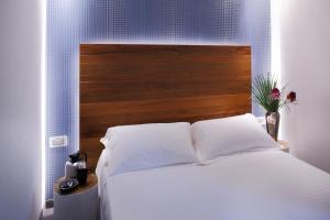 Postel nebo postele na pokoji v ubytování Q Hotel