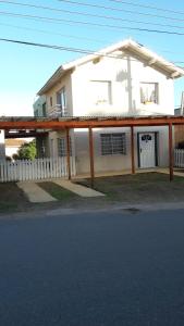 uma casa branca com uma cerca à frente. em Complejo Marce em Ostende