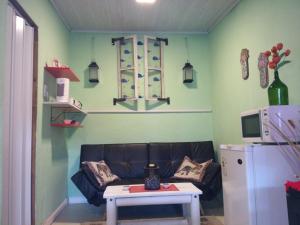a living room with a couch and a table at Playa, bosque y lago in Montevideo