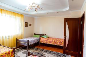a bedroom with two beds and a chandelier at Hostel Astana in Astana +31 photos