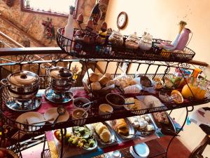 a shelf with a bunch of food on it at Pouso Realeza in Tiradentes