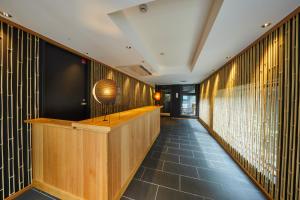 a hallway with wood paneled walls and a counter at Rinn Gion Kenninji in Kyoto