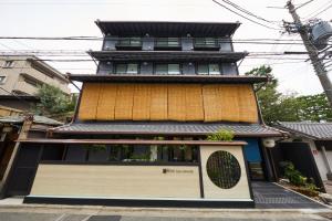 a tall building with a window in front of it at Rinn Gion Kenninji in Kyoto