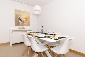 
a dining room table with a white tablecloth at Beach Condominium in Lagos
