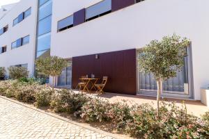 a courtyard with a table and trees in front of a building at Beach Condominium in Lagos