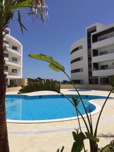 a swimming pool in front of two buildings at Beach Condominium in Lagos