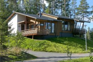 a house on top of a hill with trees at Imatran Kylpylä Spa Apartments in Imatra