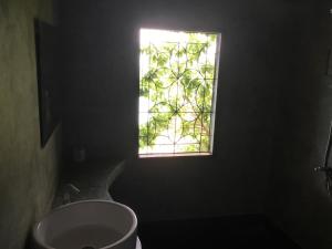 a window in a bathroom with a toilet and a sink at Chabalay Resort in Ko Tao