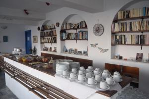 a kitchen with a counter with cups and plates at Kouros in Apollon