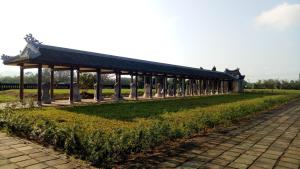 a pavilion in a park with columns in the grass at Tam Tinh Vien Homestay in Hue