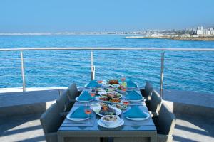 a table with plates of food on a cruise ship at Miramar Hotel Resort and Spa in Trâblous