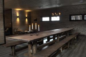 a large wooden table in a room with candles on it at Olkka ranch in Mustakulkkula
