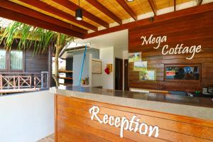 a restaurant with a reception counter in a restaurant at Mega Cottages in Nusa Lembongan