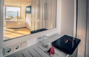 a kitchen with a table with a tray and a mirror at Nur Hotel in Kaş