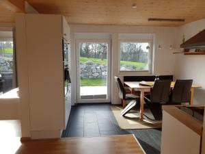 a kitchen and dining room with a table and chairs at Ferienwohnung TREIBGUT in Uhldingen-Mühlhofen