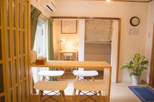 a small dining room with a table and stools at Traditional Apartment Takamatsu Guesthouse in Takamatsu