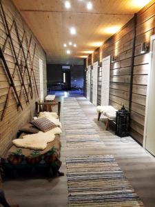 a room with two beds and a hallway with rugs at Olkka ranch in Mustakulkkula