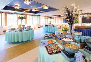 a buffet of food on a table in a room at Takamiya Hotel Jurin in Zao Onsen