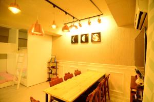 a dining room with a wooden table and chairs at Residence Unicorn in Seoul