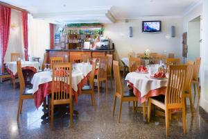 a restaurant with two tables and chairs and a counter at Domus Hotel-1 in Kyiv