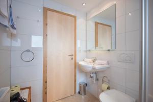 a bathroom with a sink and a toilet and a mirror at Haus Andreas in Seefeld in Tirol