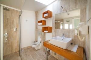 a bathroom with a sink and a toilet at Nur Hotel in Kaş
