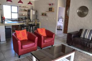 a living room with two chairs and a table at Birchwood A & B @ Clarens in Clarens +7 photos