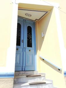a blue door on a building with stairs at Apollon Hotel in Chania