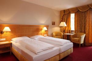 A bed or beds in a room at Hotel Regina