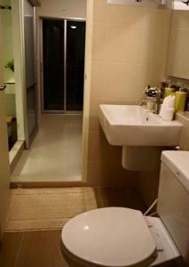 a bathroom with a toilet and a sink at Baan Thew Lom Condo Cha am By PoPu in Ban Sahakham